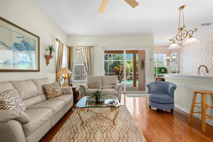 Sliding glass doors provide views of the screened lanai and pool while extending the family room's connection to the outdoors.
