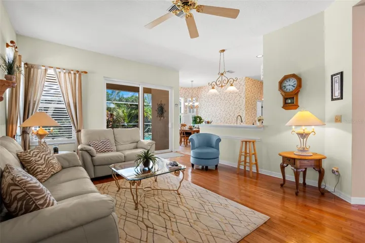 The family room enjoys abundant natural light and convenient access to the screened lanai and pool area.