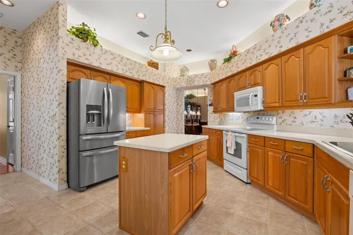 Abundant cabinetry, generous counter space, and a center island provide ample room for storage and meal prep.