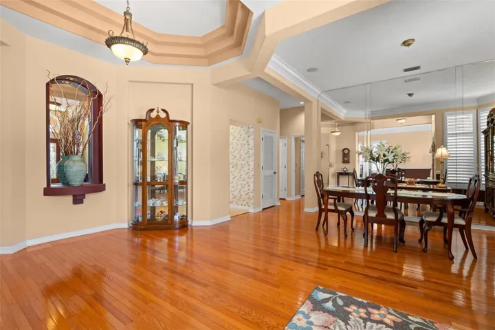 Architectural niches, a dramatic tray ceiling, and hardwood flooring highlight the craftsmanship and character found throughout the home.