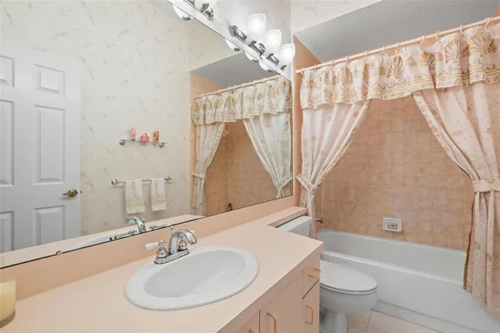 Conveniently located near the secondary bedrooms, the second bath features a tub/shower combination and vanity storage.
