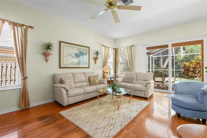 Natural light pours into the family room through multiple windows and sliding glass doors.
