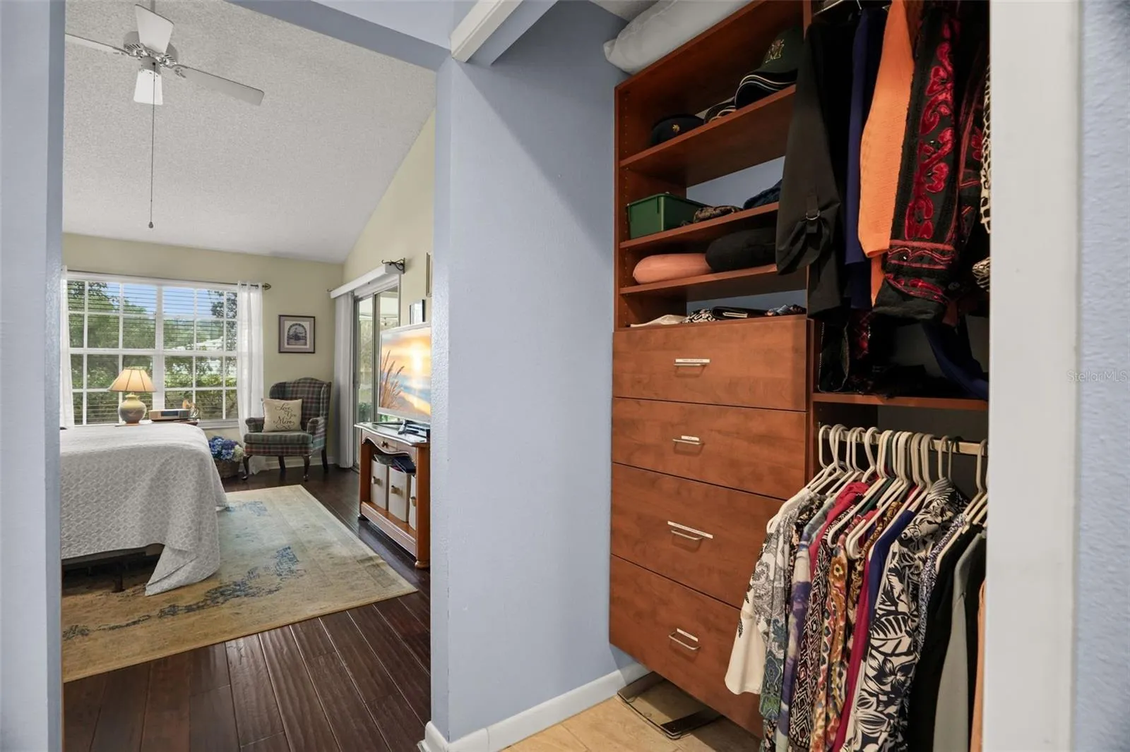 Closet with built ins towards the primary suite