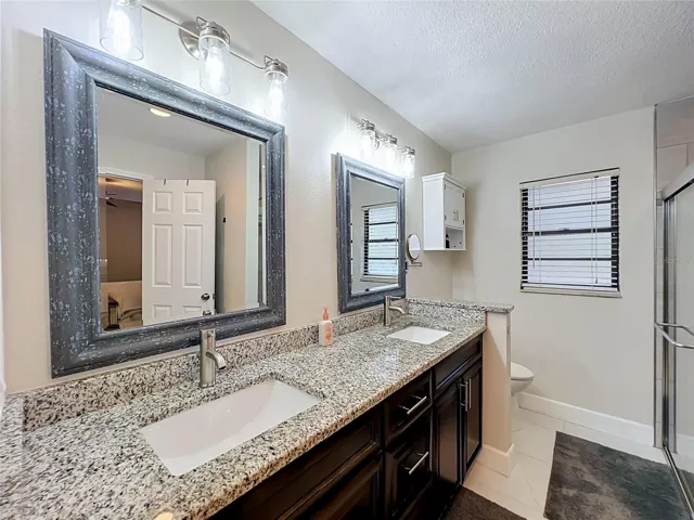 Owner's ensuite with granite countertops and dual sinks.