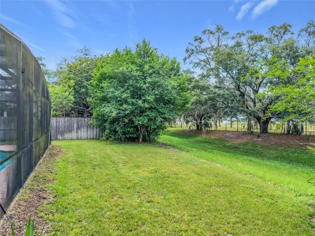 Rear view of backyard and open common area.