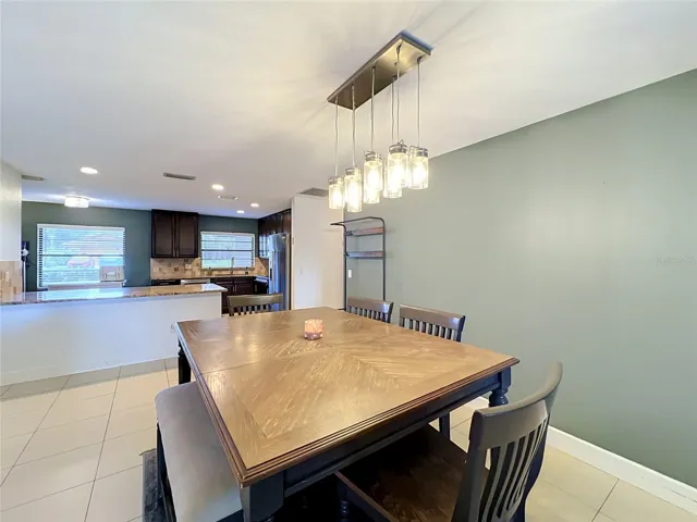 Dining room area with views of kitchen and bar area.