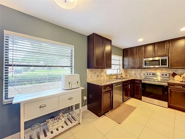 Kitchen nook and kitchen from hallway entry.