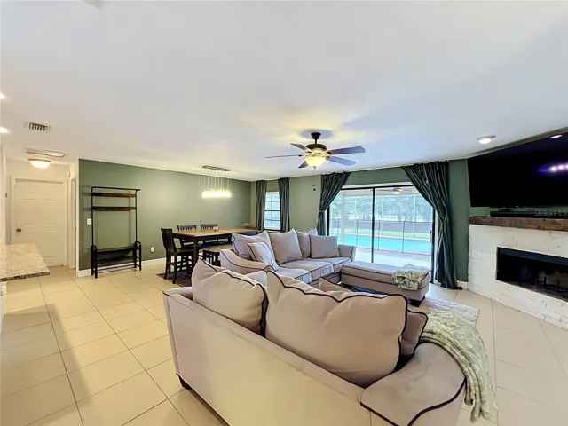 Dining/family room view showing the kitchen bar and  hallway to garage.
