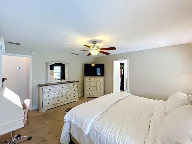 Owner's suite with views of hallway to garage and en-suite.
