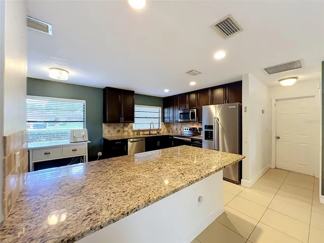 Close-up of granite topped kitchen bar for extra seating if desired.