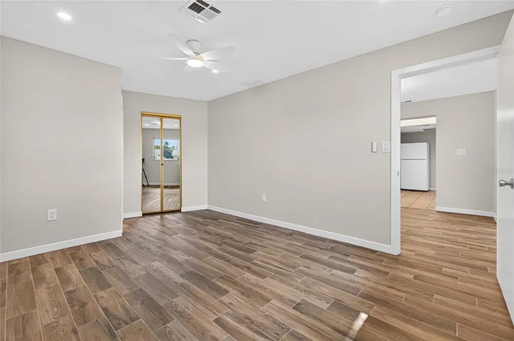 Primary bedroom with ensuite bathroom & walk-in closet.  New tile flooring, lights and ceiling fan!
