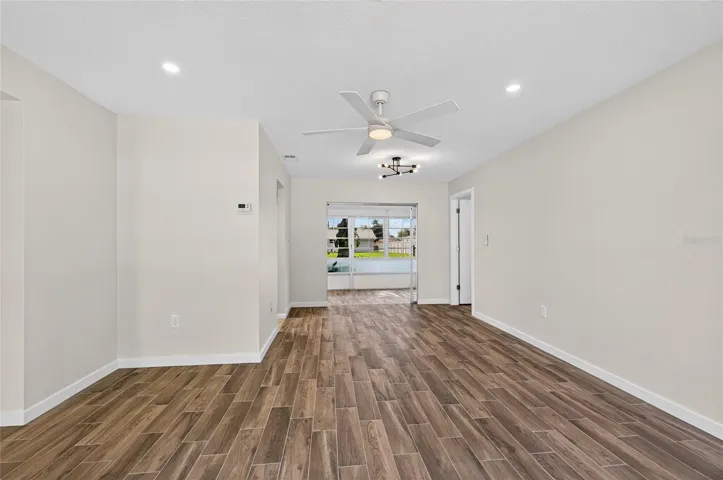 Front living room and dining with brand new tile flooring, paint, AC vents and lighting!