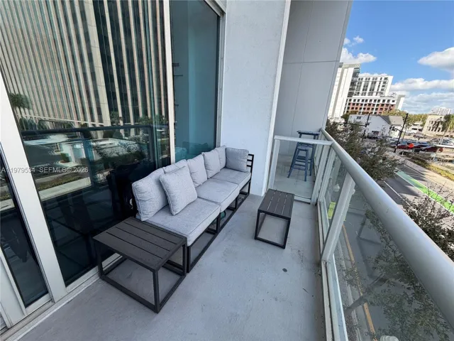 large covered balcony with furniture included