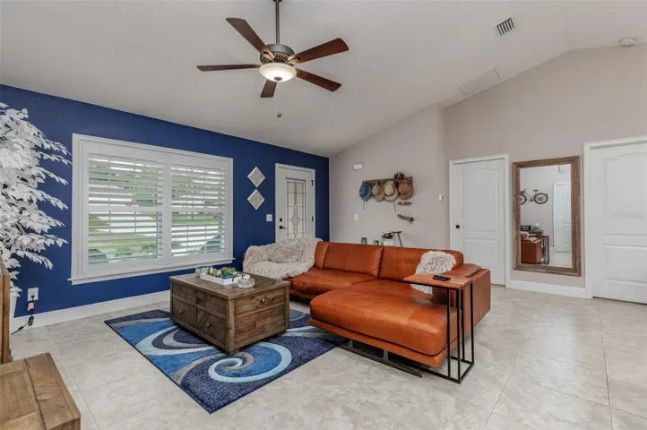 Great Room with large picture window with plantation shutters!