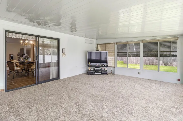 Florida room with sliders leading back to the greatroom