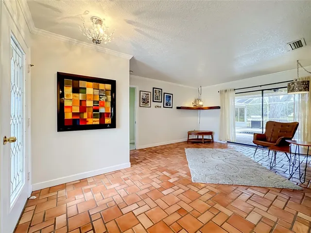 Upon entering the house, this sitting room has a view of the pool and pond beyond.
