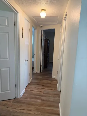 Hallway featuring new laminate flooring leading to all bedrooms