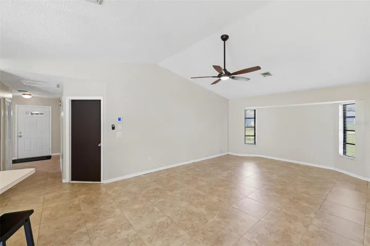 Family room with dark door leads out to the 2 car garage...