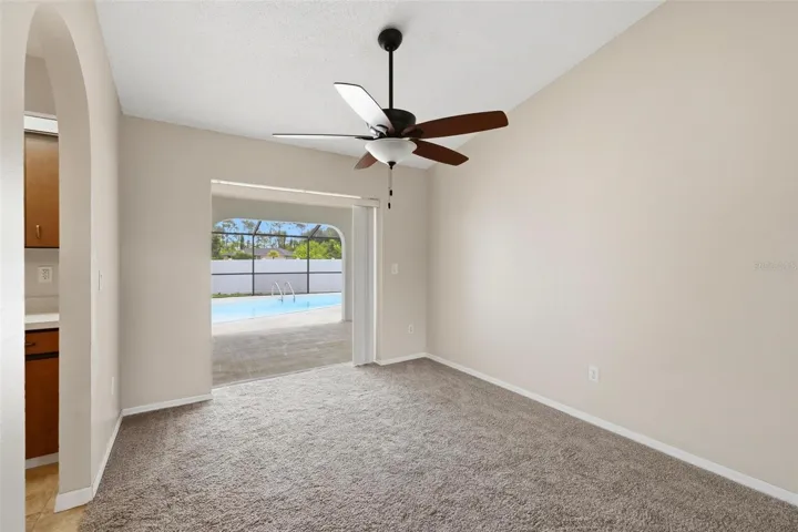 Formal dining room with pocket sliding glass door out to your screened/covered Lanai and private swimming pool
