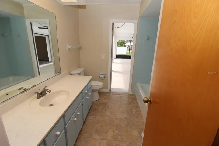 Guest bathroom with door out to the pool