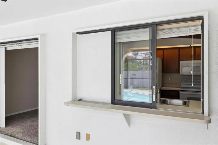 Lanai showing the passthrough sliding window to the kitchen....