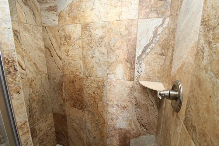 Primary Bathroom walk-in shower is beautifully tiled....