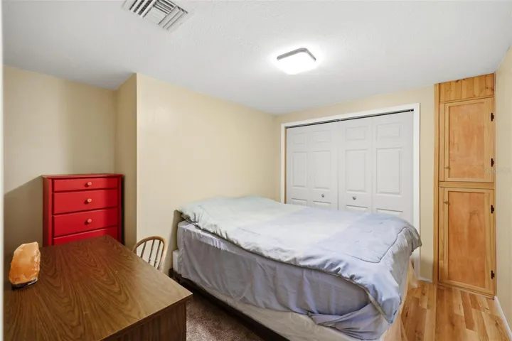 One bedroom with built in cabinet and wall closet.