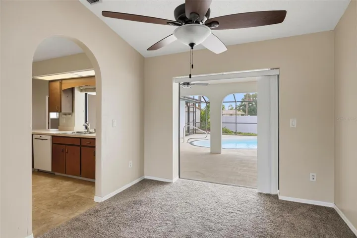 Formal Dining room with Kitchen to the left and pocket sliding glass doors out to your sparkling pool...