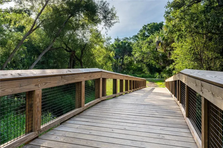 Peaceful walking paths surrounded by mature oak trees and palms.