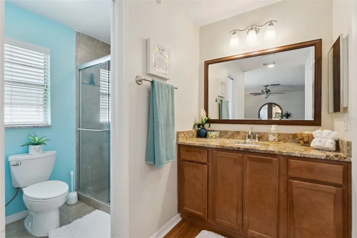 Designed with convenience in mind, the primary bath features a walk-in shower and water closet area, while the separate vanity space helps keep the mirror steam-free during busy mornings.