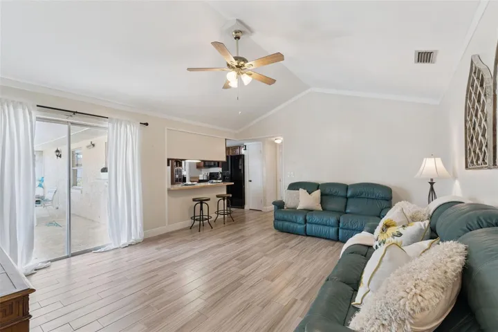 Family room/kitchen combo. Sliding glass doors lead you to your covered/screened-in lanai that overlooks the pool.