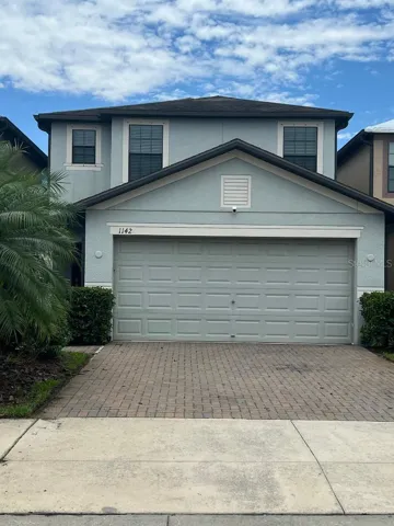 Front view of house with paver driveway