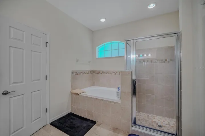 Primary bathroom with separate tub and shower.