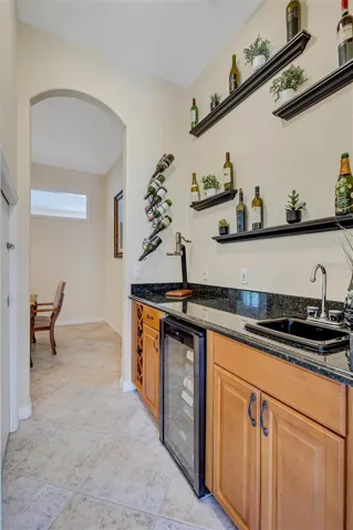 Wet bar area that passes from the formal dining area to the kitchen space.