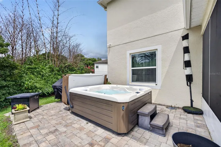 Spa Patio | Private paver patio featuring lush landscaping.