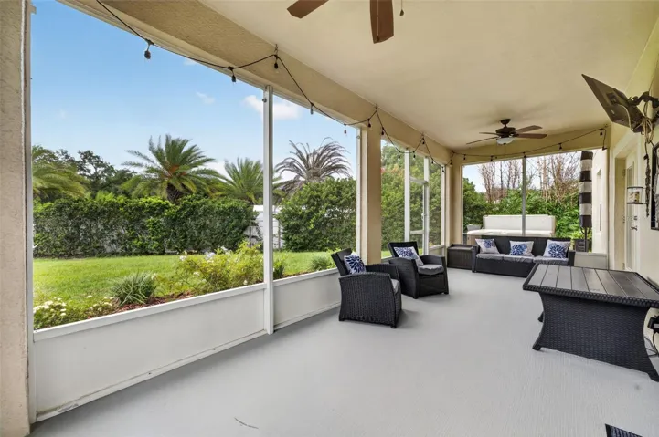 Screened Lanai Wide View | Expansive outdoor living area overlooking the backyard and mature landscaping.