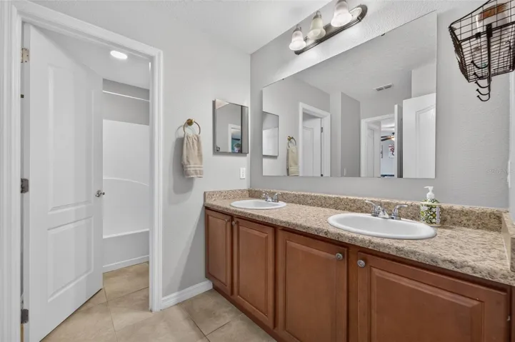 Secondary Bathroom | Full secondary bathroom with dual-sink vanity and ample storage.