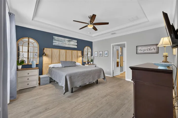 Primary Bedroom | Generous primary suite featuring tray ceilings and ample space for furnishings.