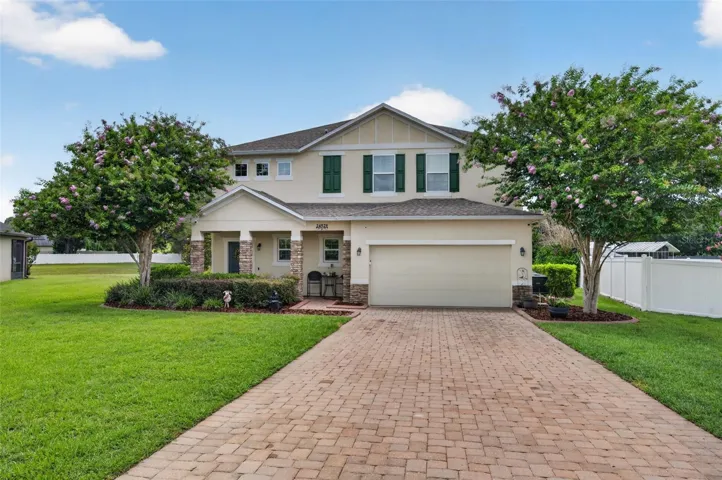 Front Exterior | Beautiful two-story residence with attractive curb appeal, manicured landscaping, and a spacious paver driveway.