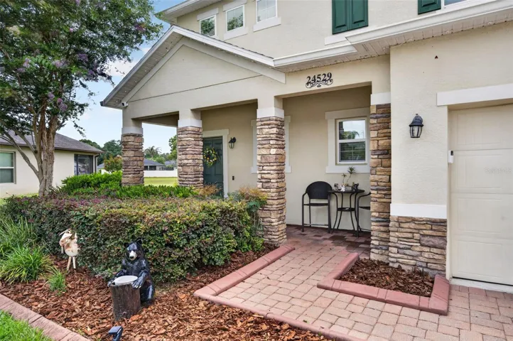Covered Front Porch | Inviting covered front porch accented with stone detailing and plenty of room to welcome guests.