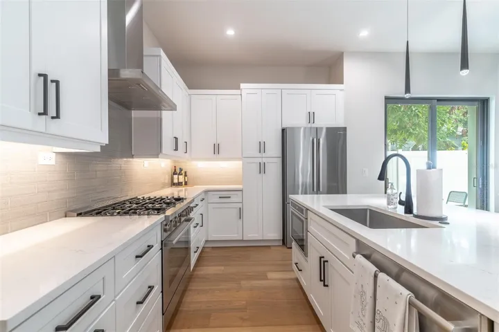 Note the details, under cabinet lighting, backsplash tile and below counter microwayve.