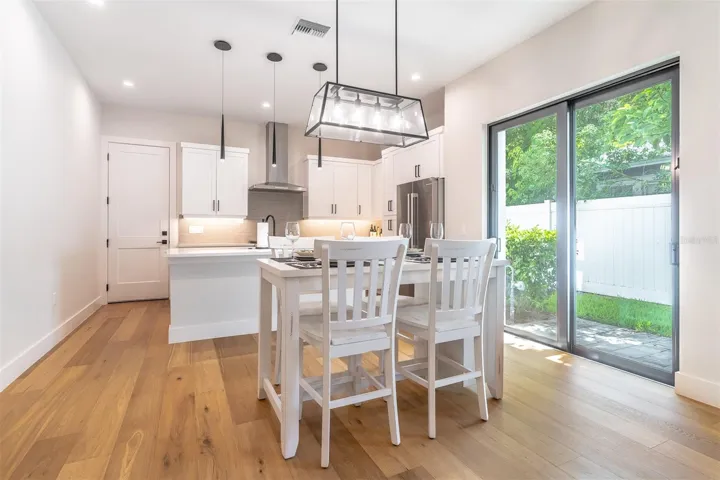 Kitchen, dining, and slider to the courtyard.