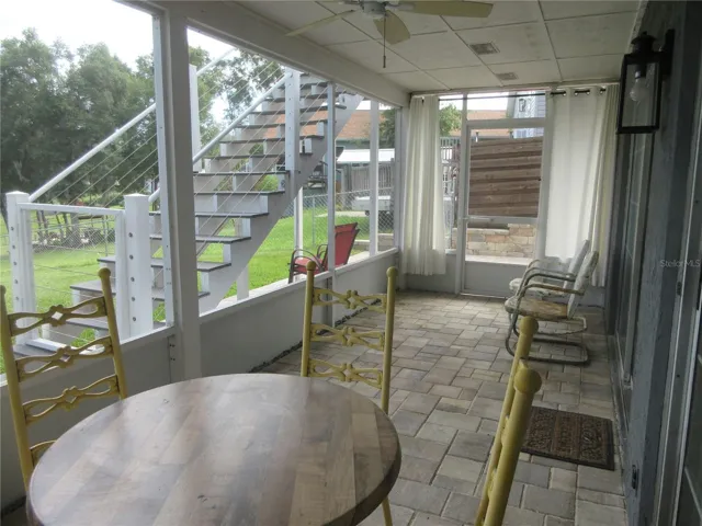 bottom story screened veranda with pavers
