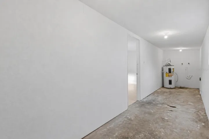 Full view of utility room with room for storage and shelves.
