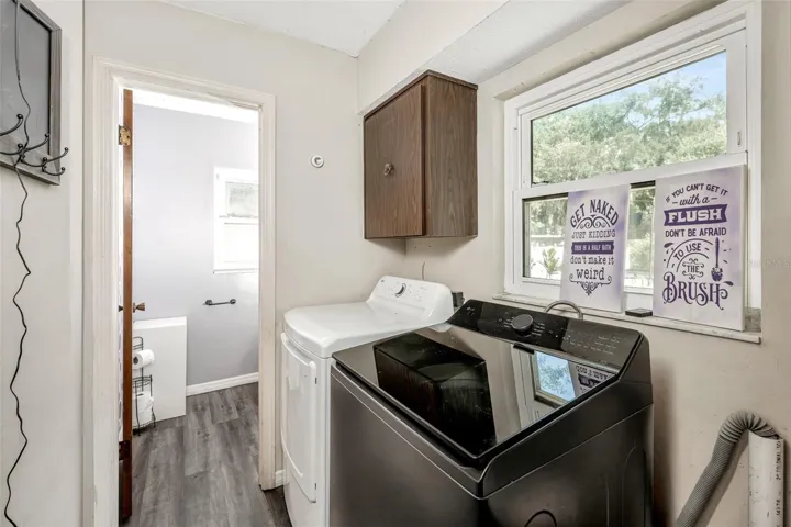 Laundry room with 1/2 bath leading from family room with
