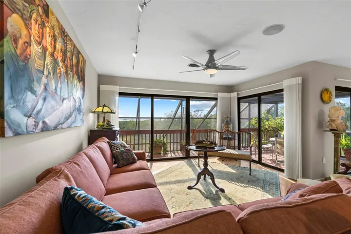living room and dining room beautiful wood floors access to the screened porch