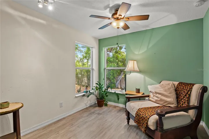 Spacious primary bedroom retreat featuring a bright and airy layout with a comfortable sitting area, creating the perfect space for relaxation and privacy. The room offers abundant natural light and a peaceful atmosphere, ideal for an owner’s suite designed for comfort and everyday living.