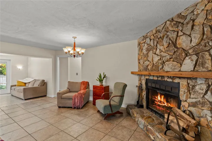 Cozy fireplace gathering area centered around a charming wood-burning fireplace, creating a warm and inviting space to relax, unwind, and enjoy time with family and friends.