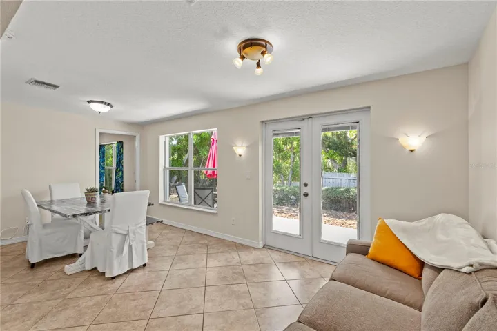 Versatile Florida room filled with natural light, offering the perfect space for a dining area, sitting room, home office, or additional living space. Large windows create a bright and airy atmosphere while providing beautiful views of the outdoors