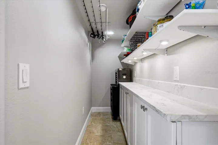 Custom Pantry with Fishing Rod Storage and Room for Tools